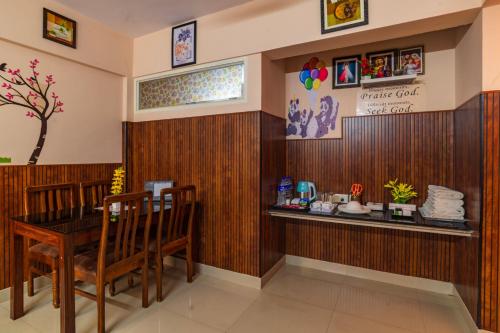 a restaurant with a table and chairs in a room at Sancta Maria Airport Hotel in Cochin