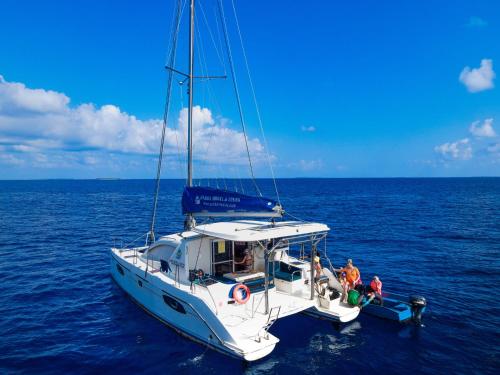 a white boat in the water with people on it at Sabba Summer Suite , Fodhdhoo in Fodhdhoo
