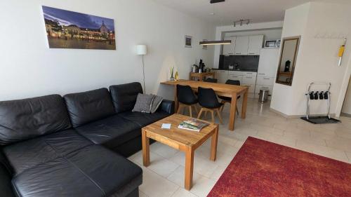 a living room with a couch and a table at FeWo Apland in Landau in der Pfalz