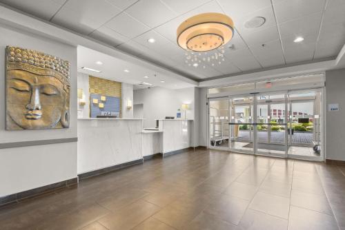 a lobby with a statue of a face on the wall at Holiday Inn Express & Suites Gonzales by IHG in Gonzales