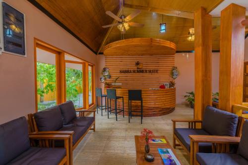 a living room with a fireplace and wooden ceilings at Sabba Summer Suite , Fodhdhoo in Fodhdhoo