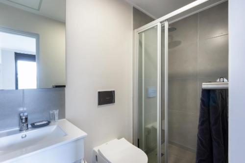 a bathroom with a shower and a toilet and a sink at 303 The Meadows George in George