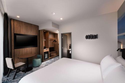 a hotel room with a white bed and a desk at DoubleTree by Hilton Hobart in Hobart
