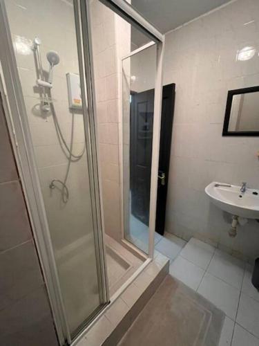 a bathroom with a shower and a sink at Appartement Baobab 2 in Pereybere