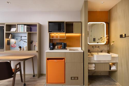 a small bathroom with a sink and a counter top at Home2 Suites By Hilton Wuxi Huishan in Wuxi
