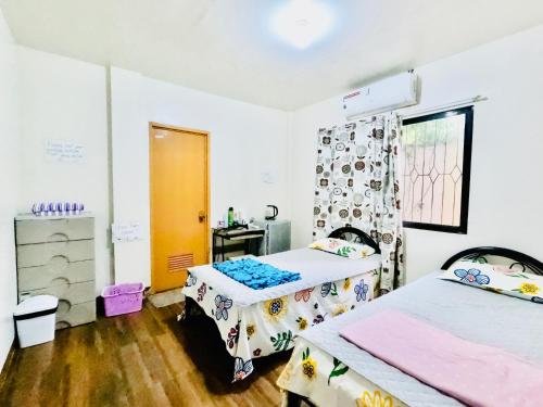 a room with two beds and a window at Lion Dive Resort in Moalboal