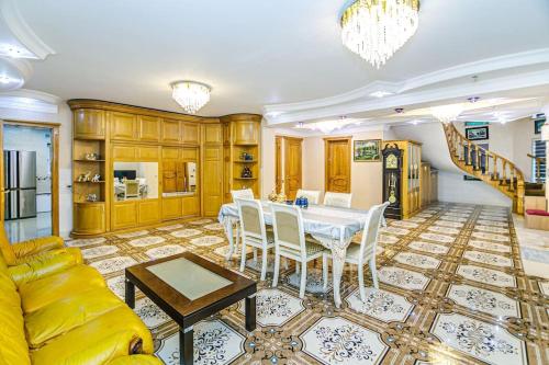 a living room with a table and a yellow couch at Luxury Villa with Breakfast in Baku