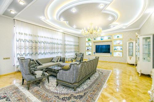 a living room with a couch and chairs and a chandelier at Luxury Villa with Breakfast in Baku