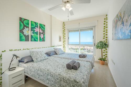 a bedroom with a bed and a window at Trebol House, Edificio Cañadas, Golf del Sur in San Miguel de Abona
