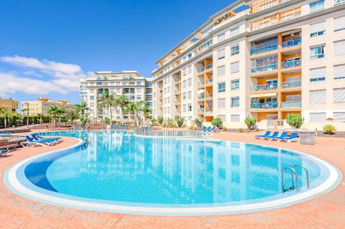 a large swimming pool in front of a building at Trebol House, Edificio Cañadas, Golf del Sur in San Miguel de Abona