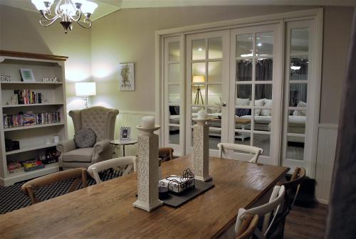 a dining room with a table and chairs and a living room at Huntington Lodge and Cottage in Mount Tomah