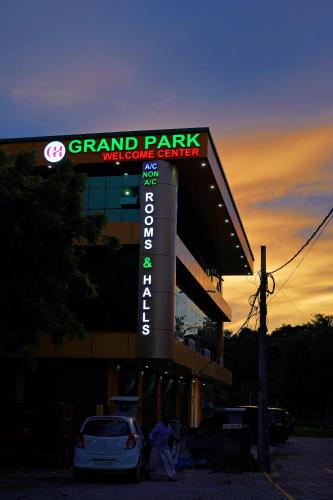 a sign for a grand park moisture center at sunset at GH Grand Park in Angamali