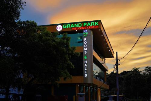 a building with a sign for a grand park movie center at GH Grand Park in Angamali