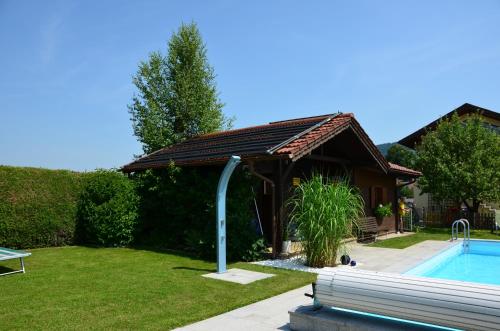 a house with a swimming pool and a gazebo at Haus Gruber in Attersee am Attersee