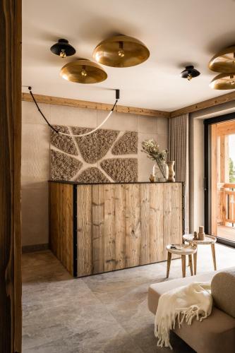 a living room with a couch and a wooden wall at Owce Dwie in Zakopane