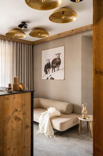 a living room with a couch and two cows at Owce Dwie in Zakopane