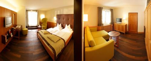 a hotel room with a bed and a couch at Romantik Hotel Im Weissen Rössl am Wolfgangsee in St. Wolfgang