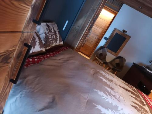 a bedroom with a large bed with a desk and a television at Monolocale walser in Formazza