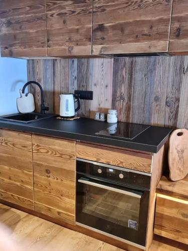a kitchen with a sink and a stove top oven at Monolocale walser in Formazza