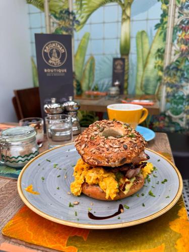 索尔科姆Brightham House - Exclusively for Adults的盘子里放着一份早餐三明治和百吉饼