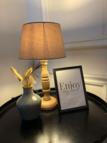a lamp and a picture on a table with a lamp and a picture at Stylish and Comfy 2 BR Apartment - Perfect for Families in Lagos