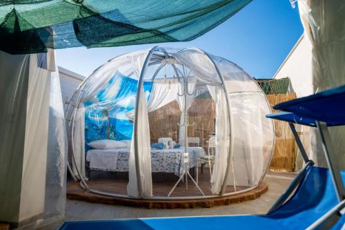 a bedroom in a dome tent with a bed in it at Oasi della pace in Bisceglie