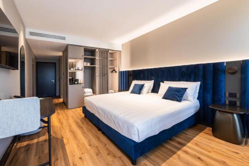 a bedroom with a large bed with blue curtains at Como Hills in Como