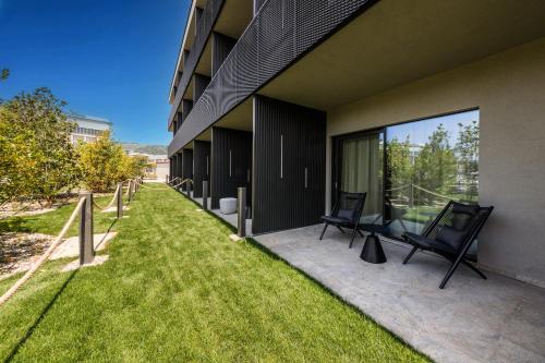 a patio with two chairs on the side of a building at Como Hills in Como