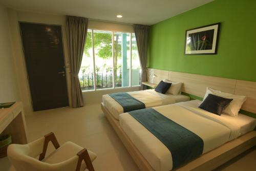 Postel nebo postele na pokoji v ubytování The Touch Green Naiyang Hotel & Fitness