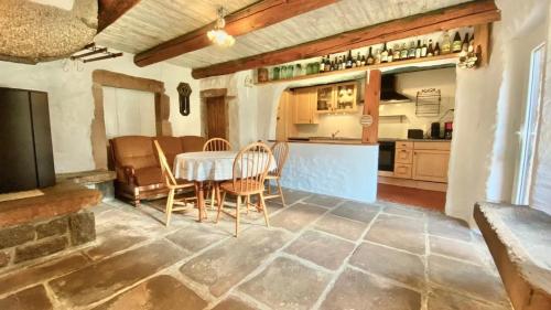 a kitchen and dining room with a table and chairs at Appartement confortable à Gerbépal 55 m² avec sauna in Gerbépal