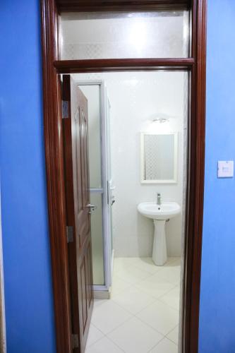 a bathroom with a toilet and a sink at AMP HOME STAY NYALI PRIVATE ROOM WITH POOL in Mombasa