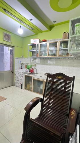 a bench sitting in a kitchen with a counter at HOMESTAY Hoàng GIa in Ấp Ông Tú