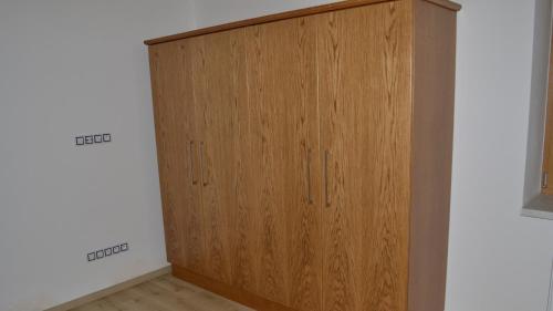 a wooden cabinet in the corner of a room at Residence Lhotka - Žďárské vrchy in Lhotka