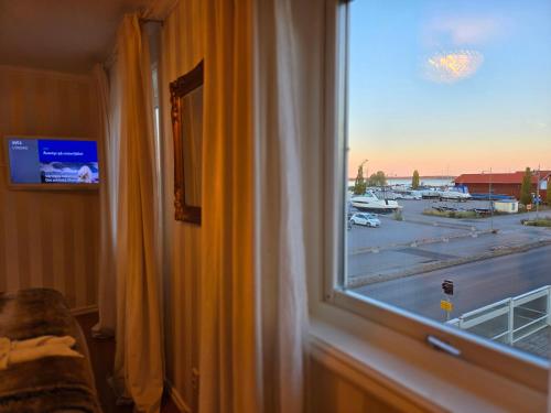 a window with a view of a parking lot at Vänerport Lakefront Hotell in Mariestad