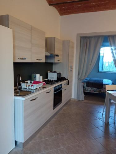 a kitchen with a sink and a stove top oven at La Dodicesima Luna in Peccioli