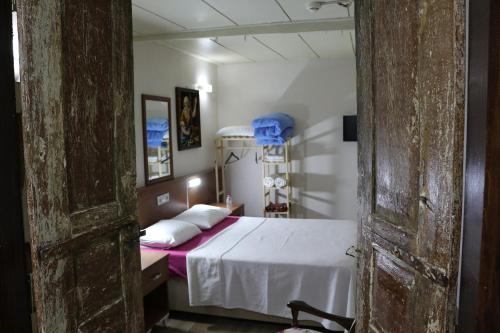 a bedroom with a bed with white sheets and white pillows at şekercigiller in Ayvalık