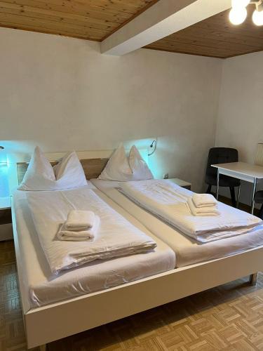 a bed in a room with two towels on it at Haus Peter in Murau