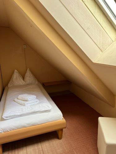 a small bed in a room under a roof at Haus Peter in Murau