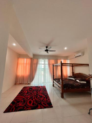 a bedroom with a bed and a ceiling fan at Homestay Seri Iskandar By Ummi in Seri Iskandar
