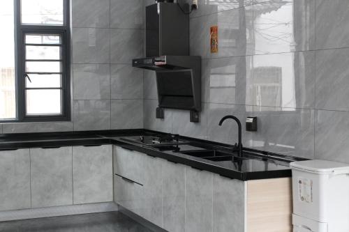 a kitchen with a sink and a stove at 大理十二花园民宿 in Dali