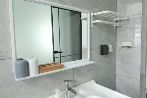 a bathroom with a sink and a mirror at 大理十二花园民宿 in Dali