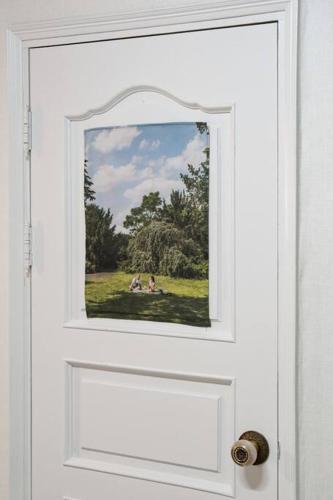a door with a picture of people sitting in a field at Anime House in Daejeon
