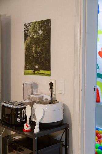 a kitchen counter with a mixer and a picture on the wall at Anime House in Daejeon