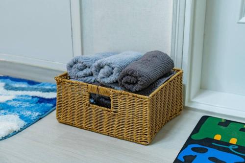 a wicker basket with towels in a bathroom at Anime House in Daejeon