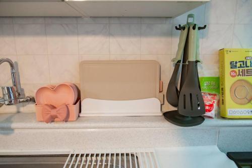 a kitchen counter with a toaster next to a sink at Anime House in Daejeon