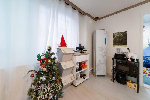 a living room with a christmas tree and boxes at Anime House in Daejeon
