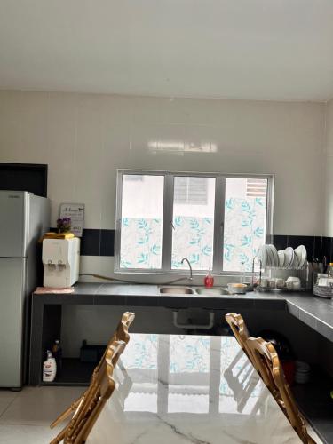 a kitchen with a sink and a window in it at Homestay Seri Iskandar By Ummi in Seri Iskandar