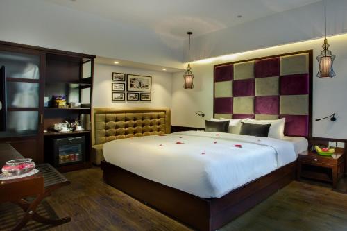 a bedroom with a bed and a dresser at Hanoi Marvellous Hotel & Spa in Hanoi