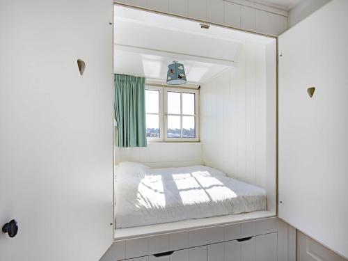a mirror in a white room with a bed at Villa by Tjeukemeer with Private Jetty in Delfstrahuizen