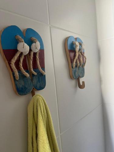 a bathroom with a towel hanging on a wall at Apartamento em condomínio com passeio incluso in Baixio
